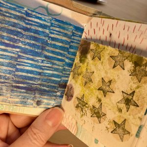 Handmade book showing stamped patterns