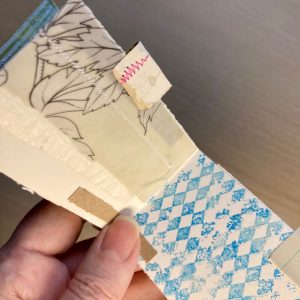 Hand holding a small handmade art journal