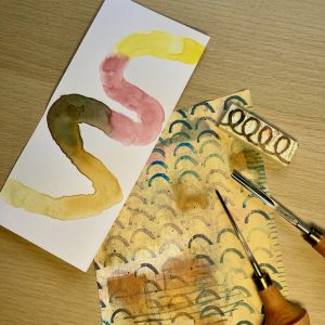 Pieces of paper with different painted patterns on